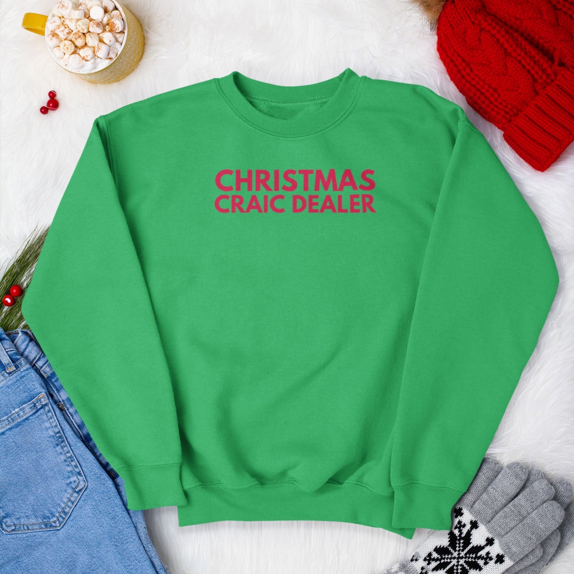 Green sweatshirt with red 'Christmas Craic Dealer' text on a white background with festive items.