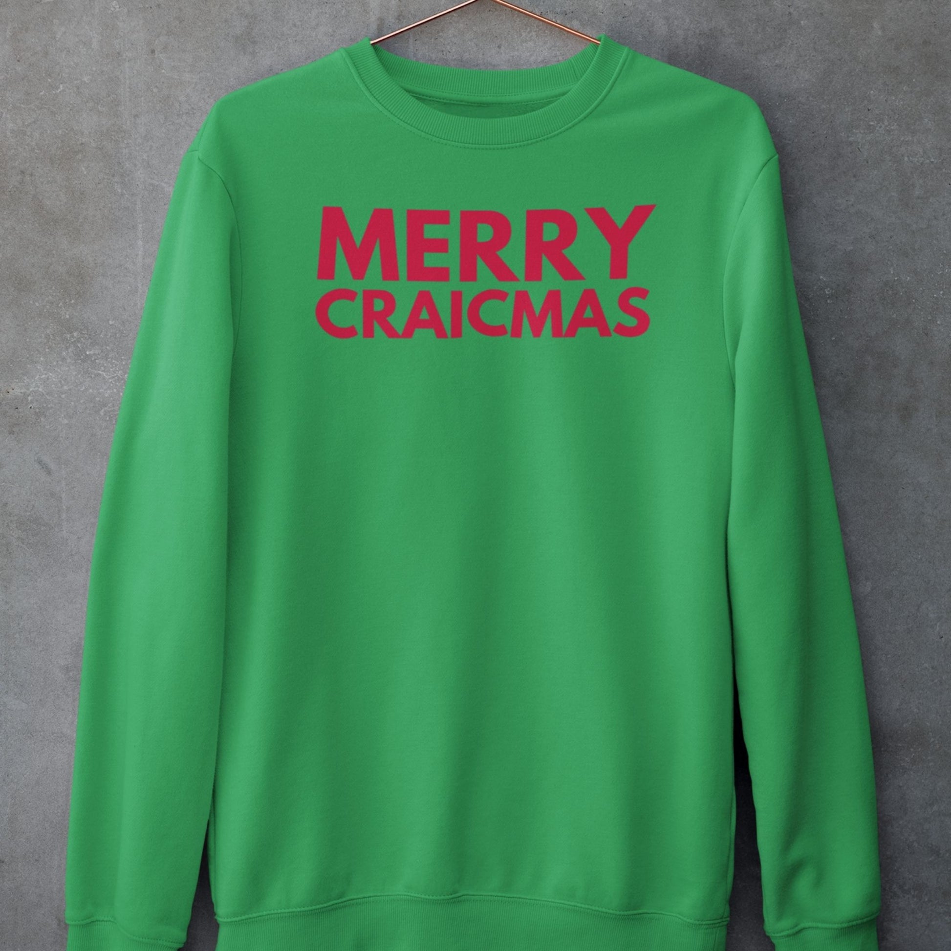 Green sweatshirt with 'MERRY CRAICMAS' red text on a gray background