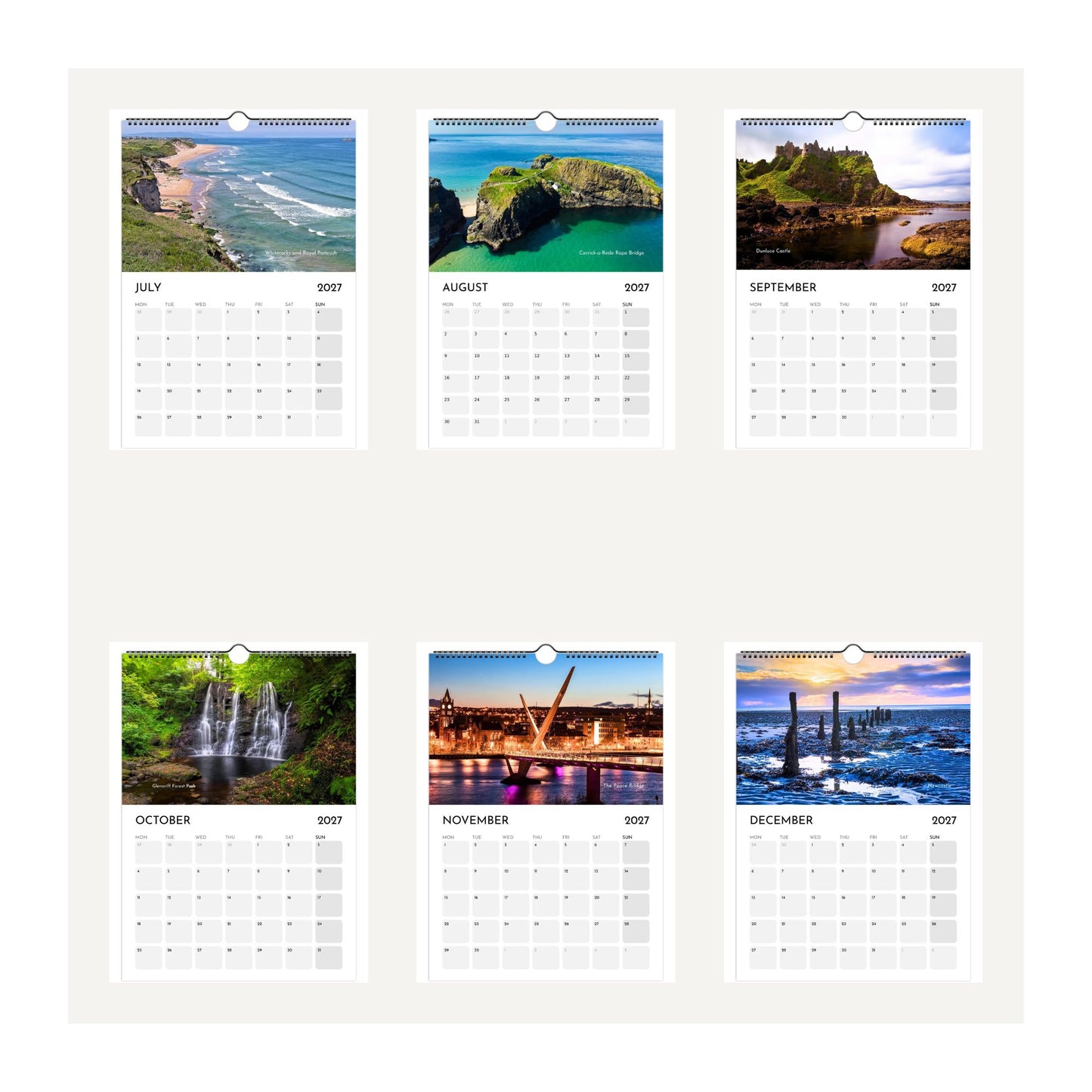 Six-months of Northern Ireland wall calendar thumbnail images displayed on a light beige background, featuring landscape and architectural photographs for each month from July 2027 to December 2027.