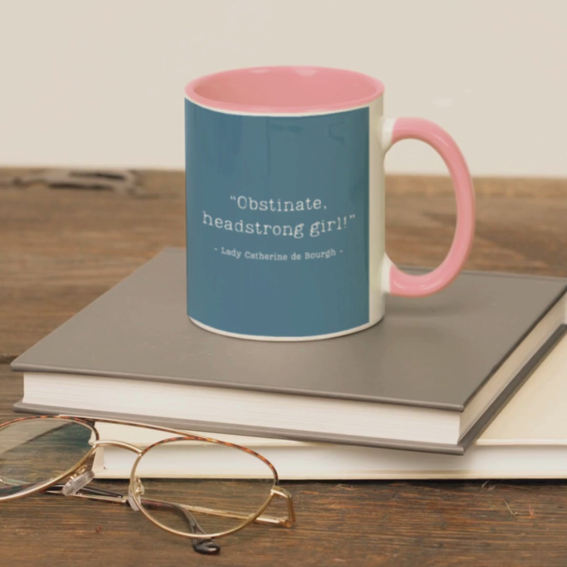 Pride and Prejudice quote mug on a pile of books