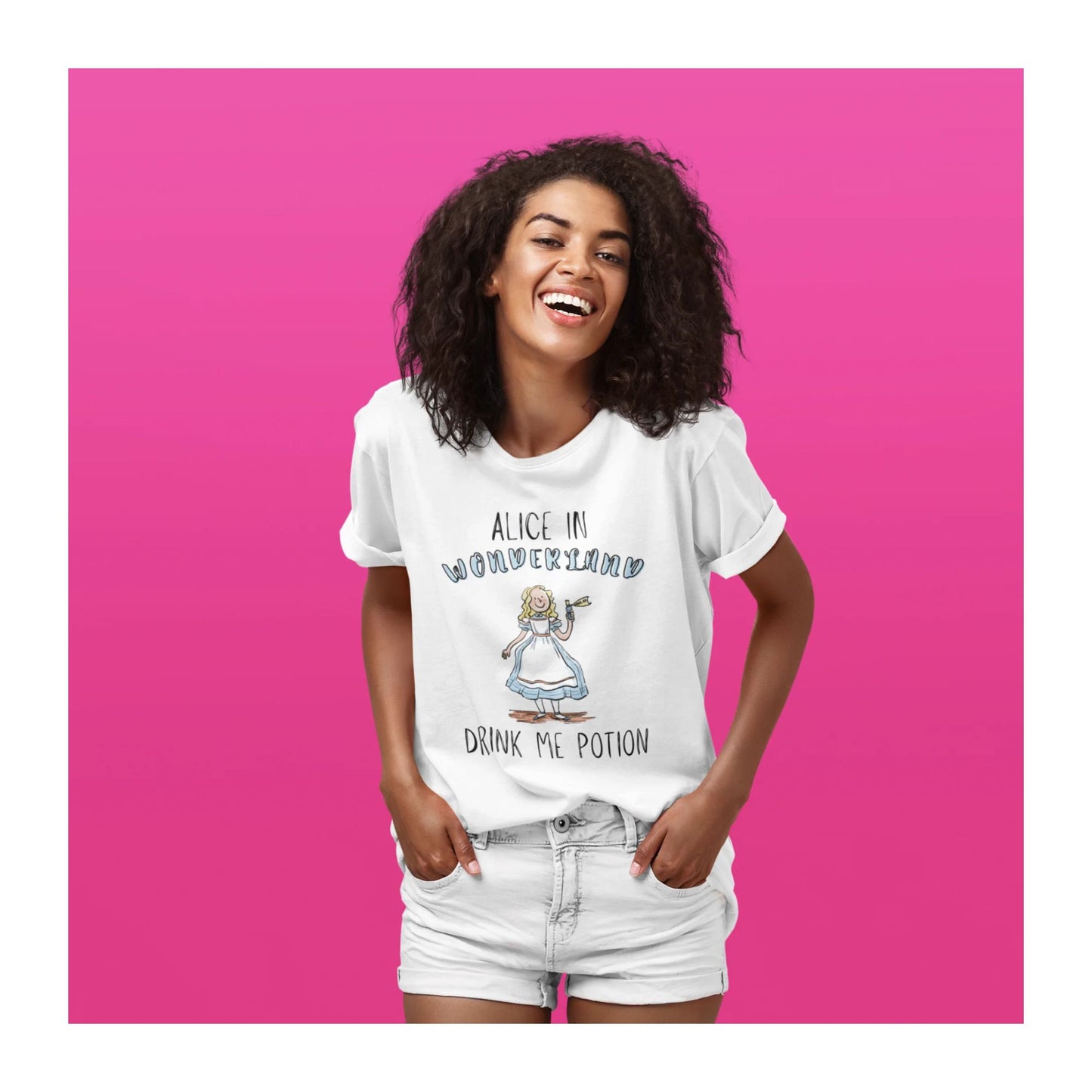 Woman wearing a white t-shirt with 'Alice in Wonderland' design on a pink background