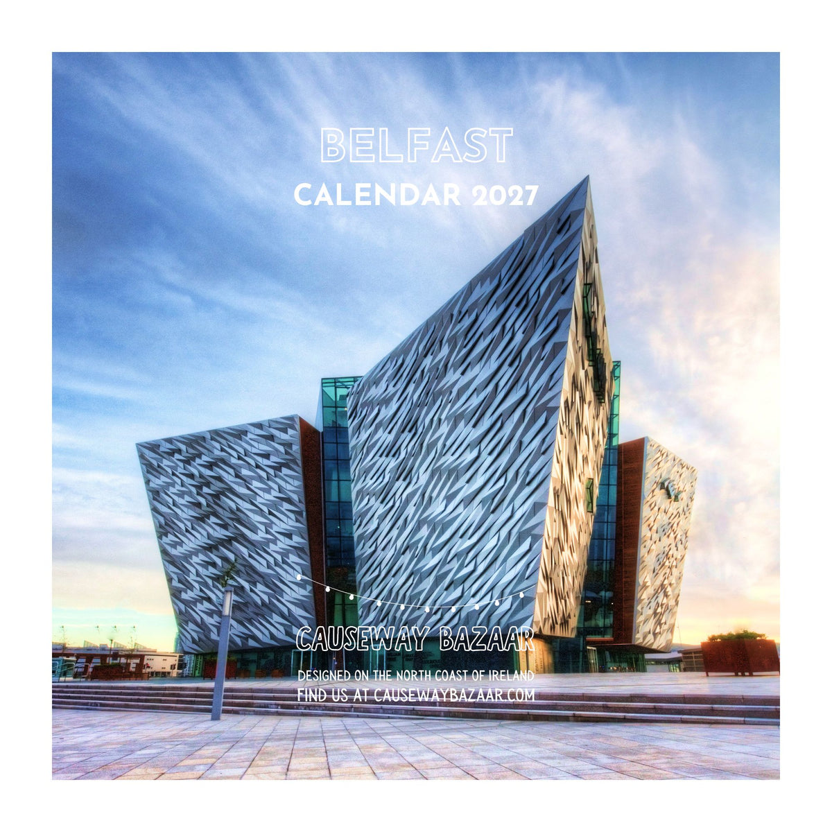 Belfast Calendar 2027 featuring a photograph of the Causeway Building in Belfast under a blue sky, with white text reading 'BELFAST CALENDAR 2027' and 'CAUSEWAY BAZAAR'.