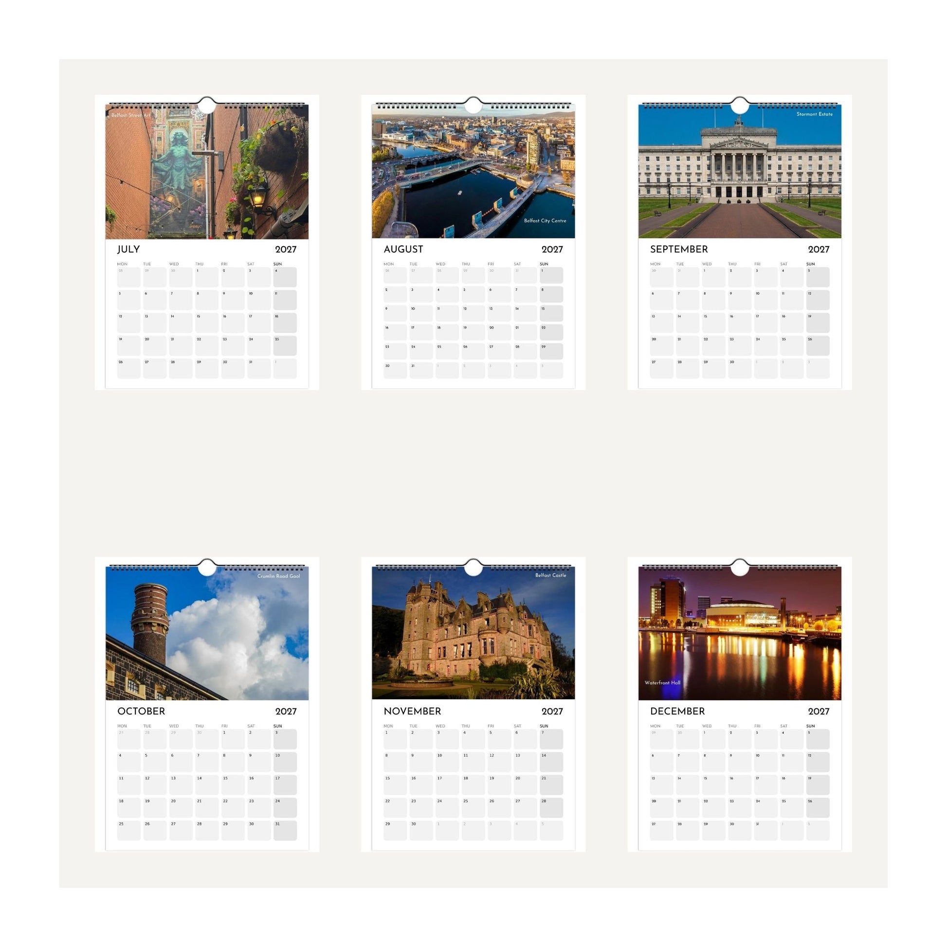 Six thumbnail images from the Belfast 2027 wall calendar, showing monthly pages with scenic photographs and grids for days of the week July to December 2027. The pages are arranged in two rows on a light beige background.