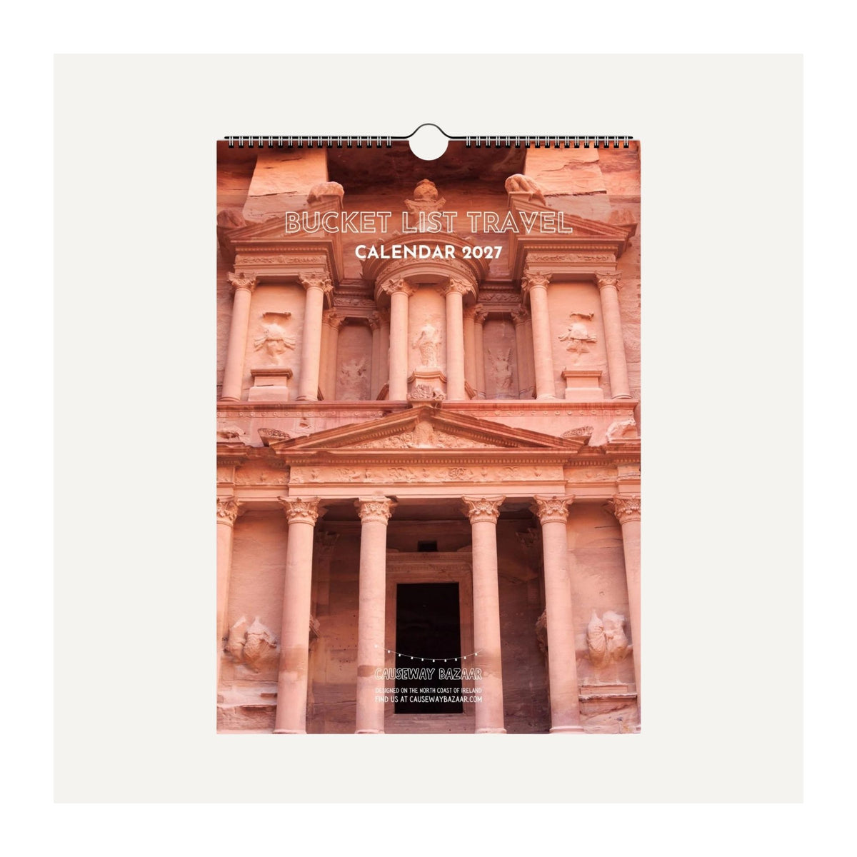 Bucket List Travel Calendar 2027 wall calendar mock-up featuring Petra, Jordan, showing the spiral-bound A4 travel calendar design and front cover.