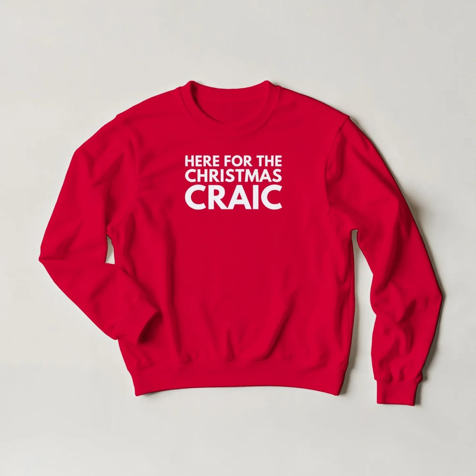 Red sweatshirt with white text 'HERE FOR THE CHRISTMAS CRAIC' on a light grey background