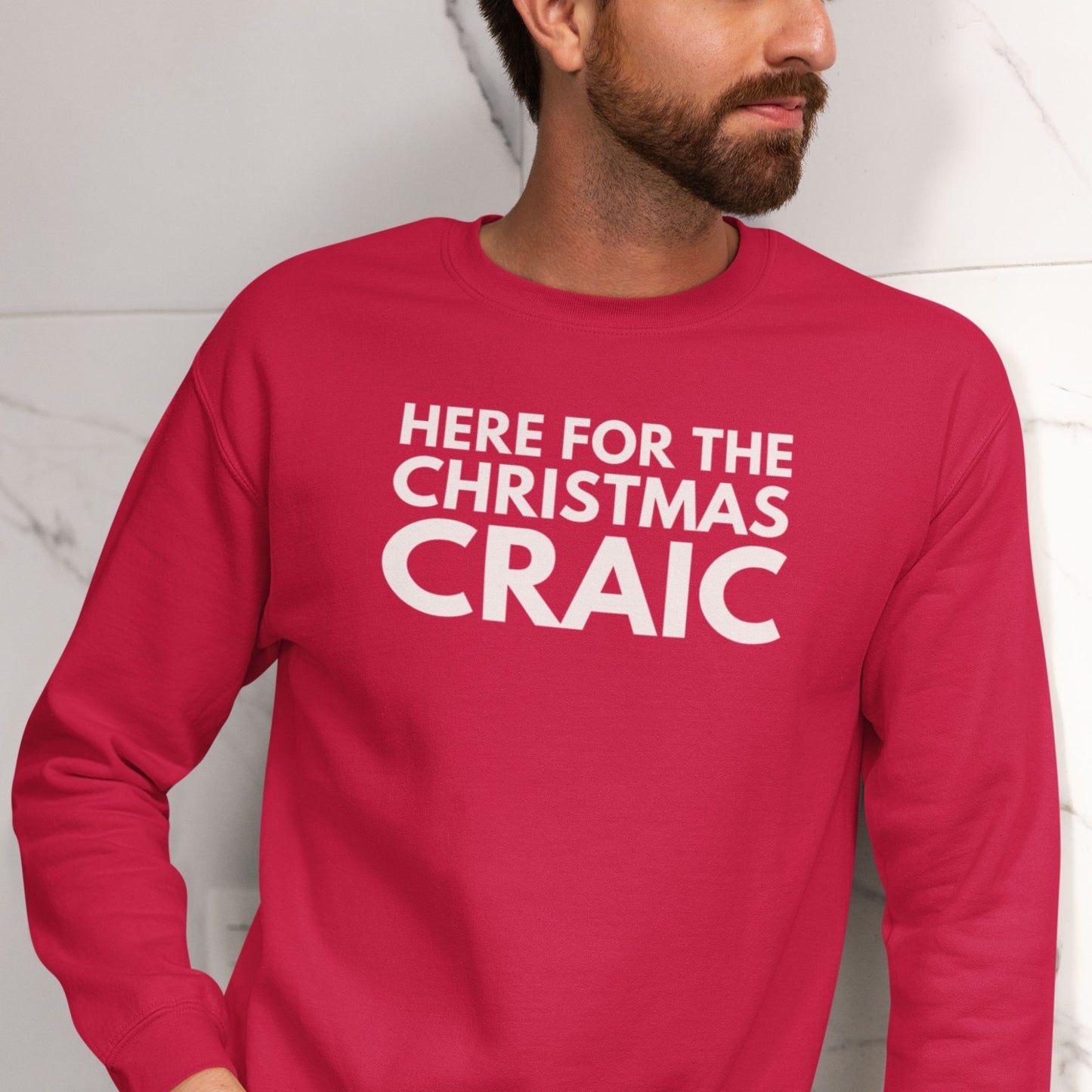 Red long-sleeve sweatshirt with white text 'HERE FOR THE CHRISTMAS CRAIC' worn by a person.