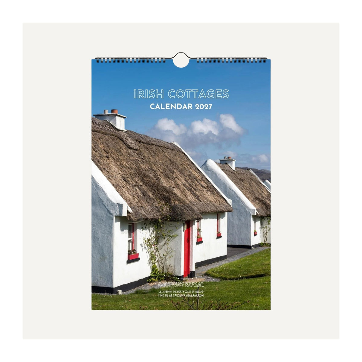 Irish Cottages Calendar 2027 spiral-bound wall calendar mock-up featuring traditional thatched cottages in Connemara, County Galway, Ireland.