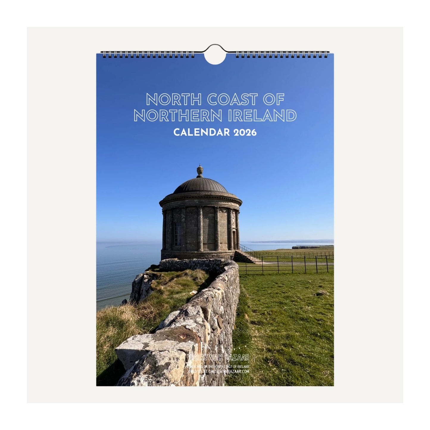 Front cover detail view of North Coast of Northern Ireland wall calendar 2026 featuring Mussenden Temple with a blue sky