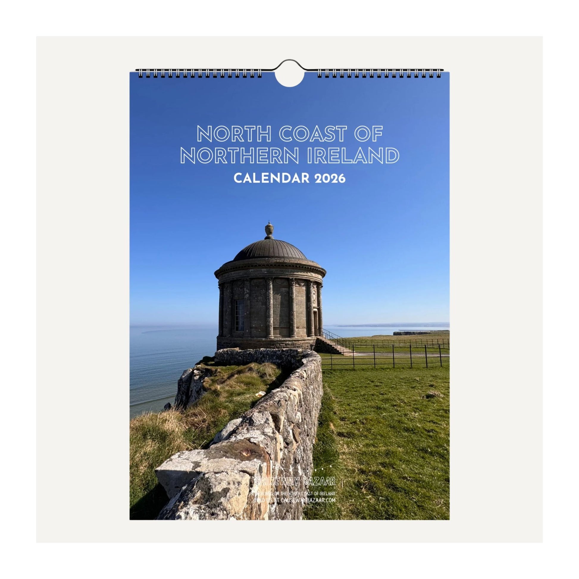 Front cover detail view of North Coast of Northern Ireland wall calendar 2026 featuring Mussenden Temple with a blue sky