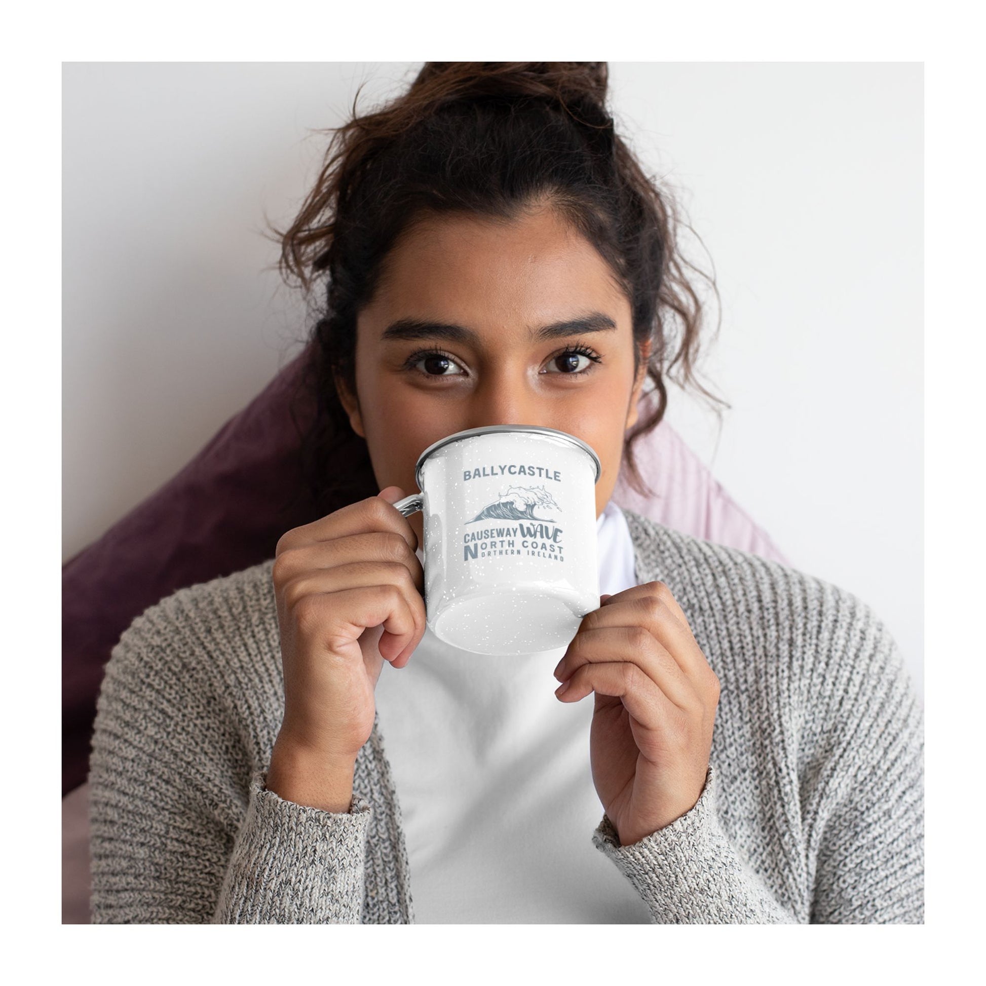 Model drinking from white mug with Ballycastle Causeway Wave North Coast Northern Ireland text and wave graphic on a white background
