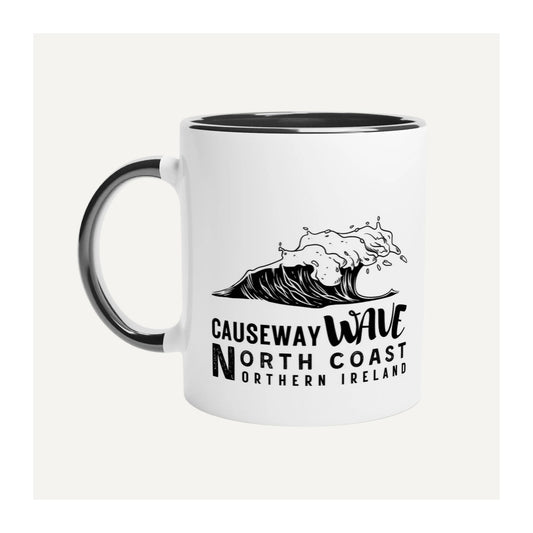 White mug with black handle featuring a wave design and Causeway Wave North Coast Northern Ireland text on a white background