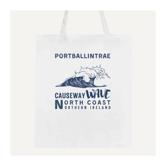 White tote bag with Portballintrae Causeway Wave North Coast Northern Ireland blue text and wave design on a white background
