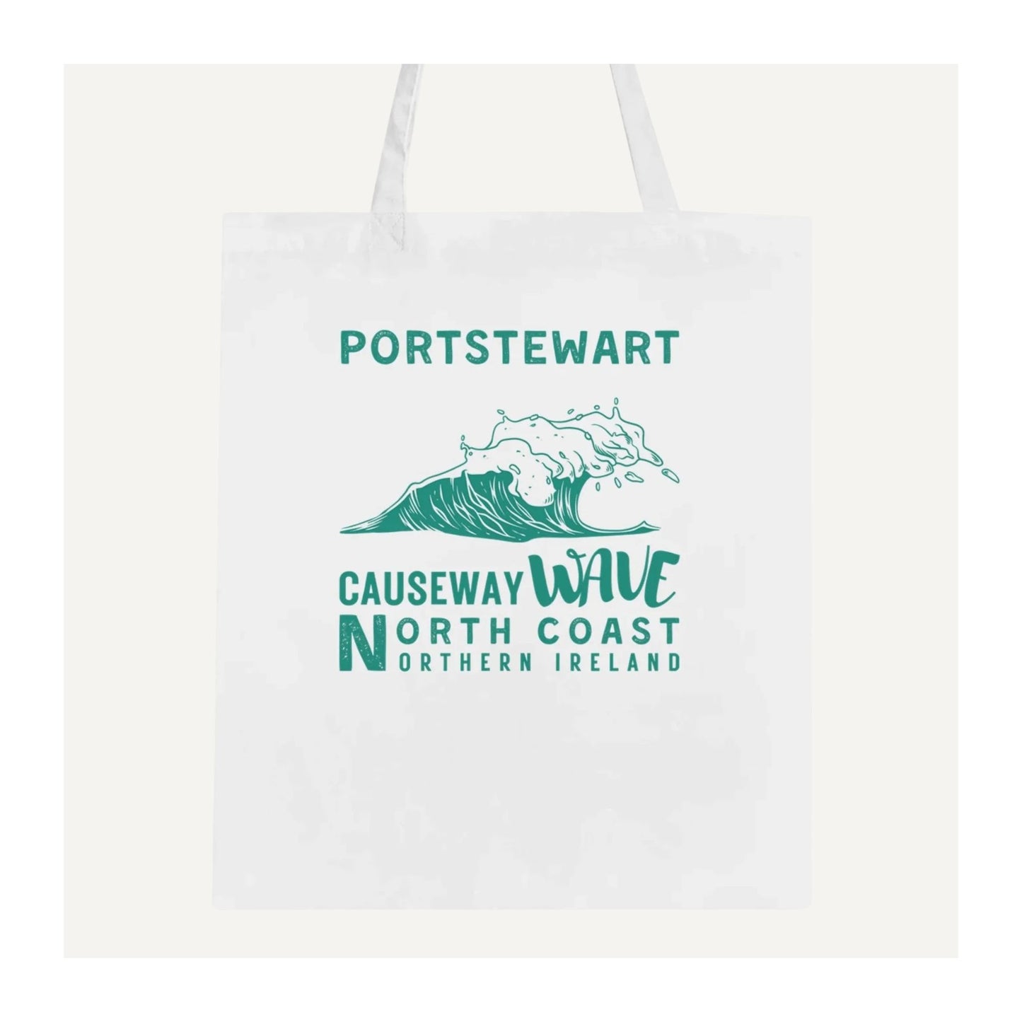 White tote bag with 'Portstewart Causeway Wave North Coast Northern Ireland' green text and wave design on a white background