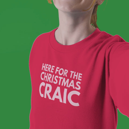 funny red irish christmas jumper with pink text saying here for the christmas craic