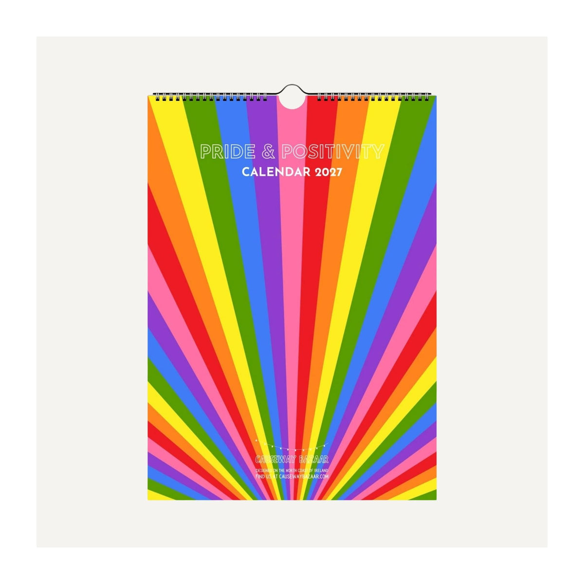 Pride & Positivity Calendar 2027 shown as a spiral-bound wall calendar with colourful rainbow sunburst cover. Bright LGBTQ+ calendar featuring 12 monthly positive affirmations, bold typography and practical planning pages for 2027.