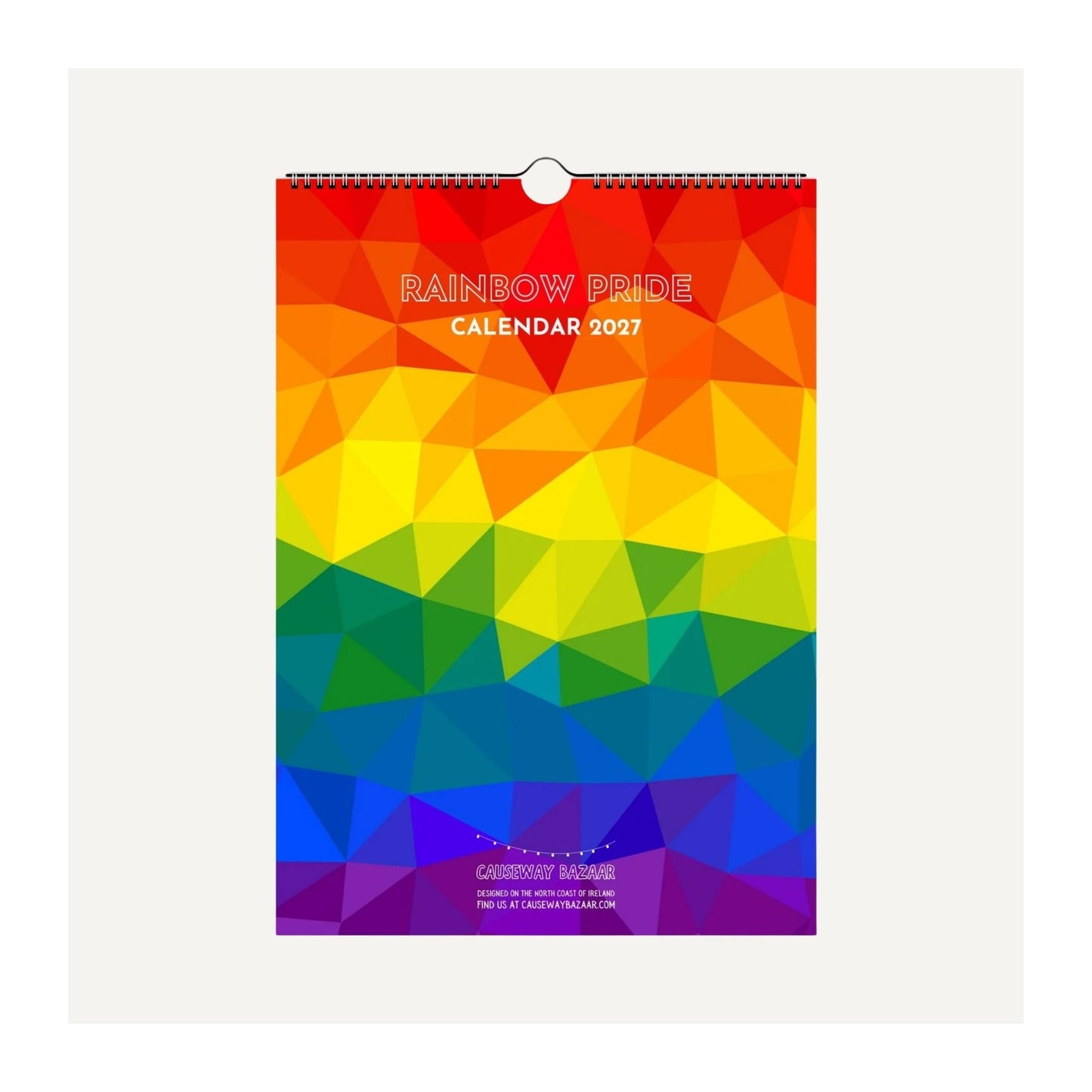 A 2027 Rainbow Pride wall calendar with a geometric low-poly rainbow design, featuring a spiral binding at the top, shown against a light gray background. Perfect for LGBTQ+ allies and friends.
